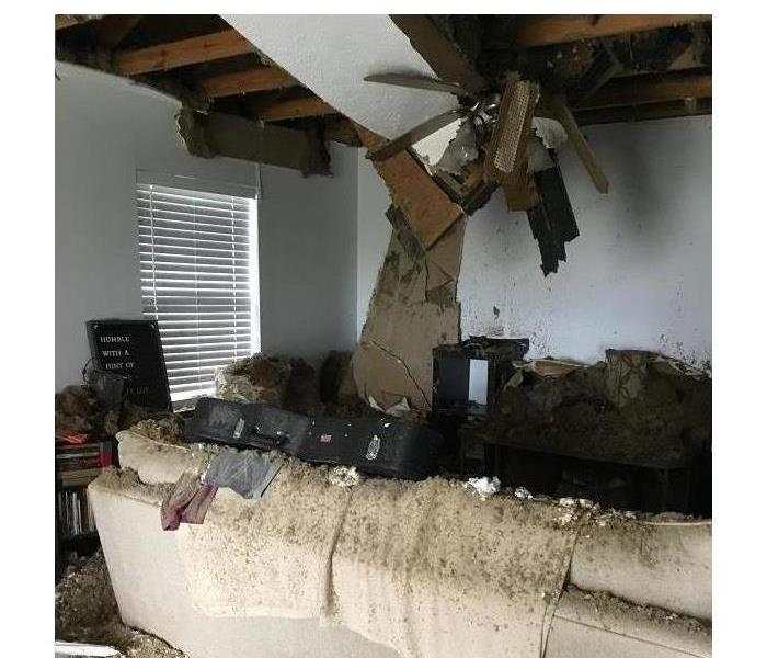 Debris from outside and the neighbors home is present inside our customer's living room.  